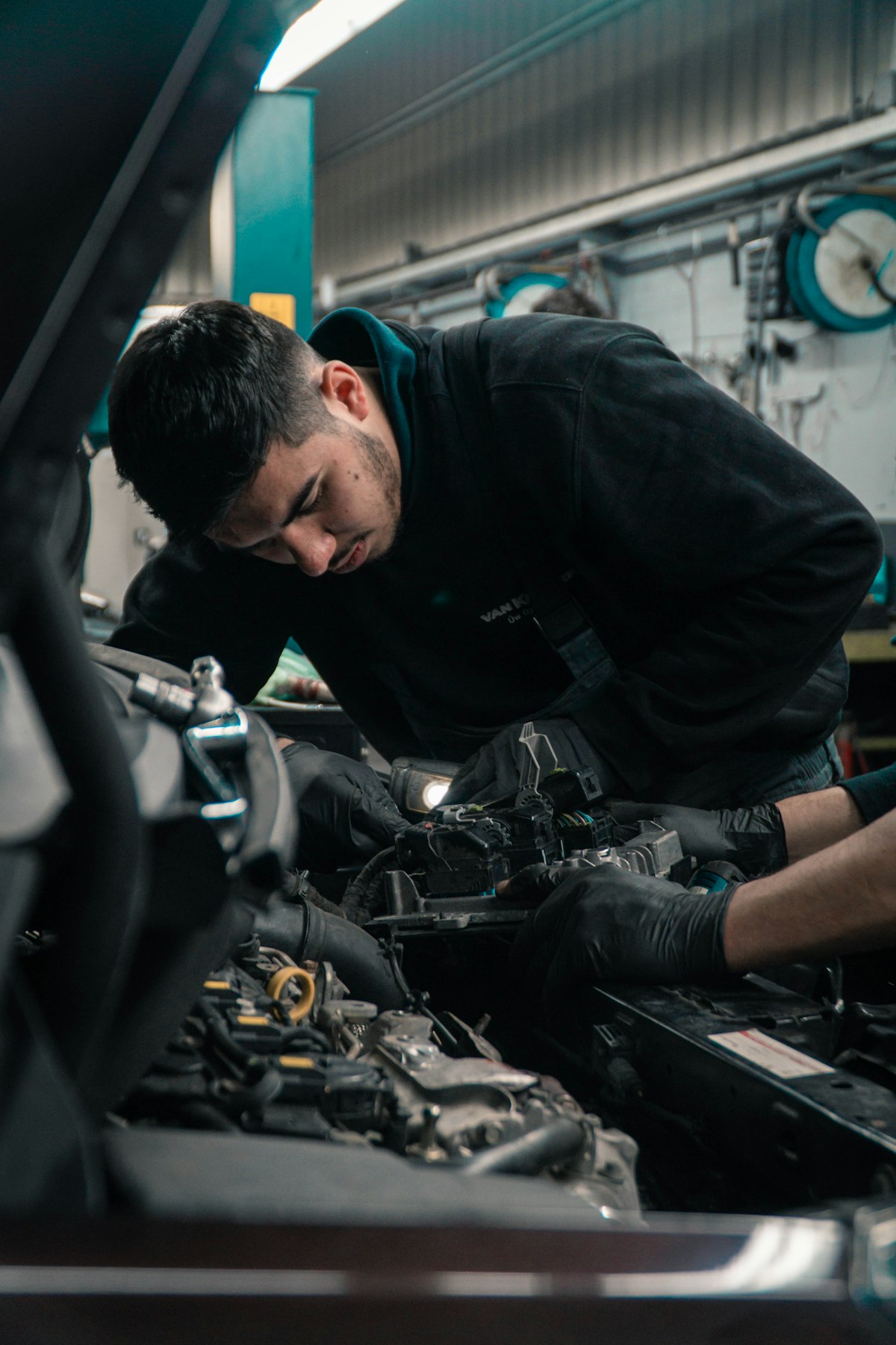 DVC Auto technician repairing a vehicle engine at the Kempton Park workshop